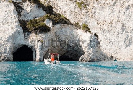 Captivating turquoise waters and dramatic cliffs frame a leisurely boat ride in Zakynthos, evoking the serene beauty and adventure of this Greek island paradise