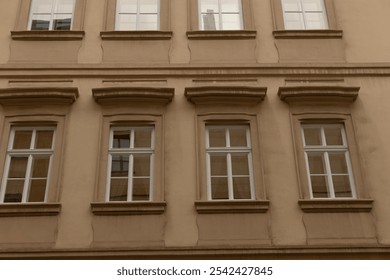 A captivating view of a classic building facade with symmetrical windows and intricate architectural details - Powered by Shutterstock