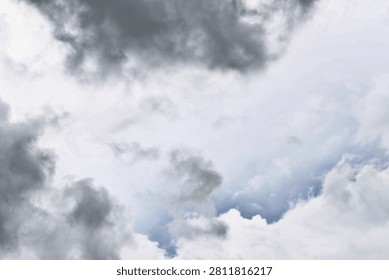A captivating view of a cloudy sky featuring varying shades of gray. This atmospheric scene captures the essence of nature's beauty and mood.