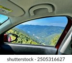 Captivating View of Lac de Kruth-Wildenstein and Vosges Mountains Framed by Car Window During a Scenic Drive on Route des Crêtes, Alsace-Lorraine, France