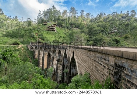 A captivating view of the Nine Arch Bridge, in Demodara, Sri Lanka. The high arch bridge, made of cement and bricks, dates back to the British colonial period.
