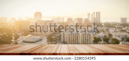 Capture the essence of city life with a blurred background from a balcony view, showcasing buildings and the bokeh lights of downtown, perfect for outdoor counter displays or home decor.