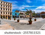 "Capture the lively atmosphere of Plaza Vieja in Havana with its colorful colonial buildings and cobblestone streets, showcasing the rich history and vibrant culture of Cuba capital city.