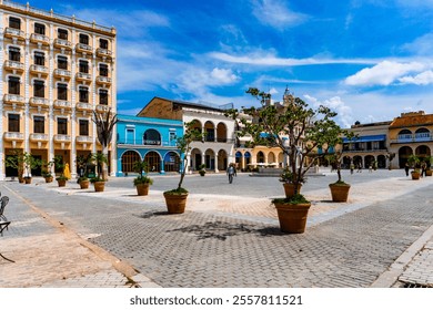 "Capture the lively atmosphere of Plaza Vieja in Havana with its colorful colonial buildings and cobblestone streets, showcasing the rich history and vibrant culture of Cuba capital city. - Powered by Shutterstock