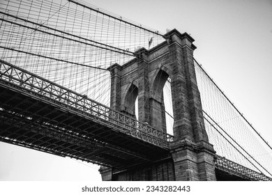 Capture the majestic allure of the Brooklyn Bridge, an architectural marvel spanning the East River in New York City. Witness the beauty of urban engineering in this stunning stock photo. - Powered by Shutterstock