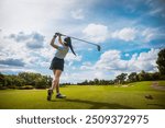 Capture the thrill of golf with this high-resolution image showcasing a golfer in mid-swing on a lush green fairway. The golfer, dressed in modern athletic wear, demonstrates perfect form as they stri