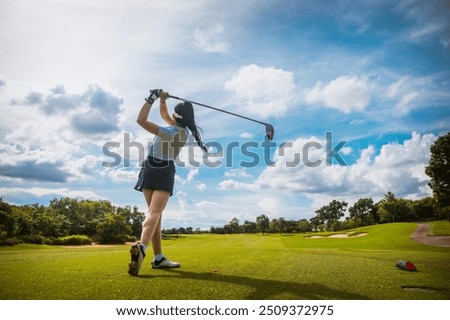 Capture the thrill of golf with this high-resolution image showcasing a golfer in mid-swing on a lush green fairway. The golfer, dressed in modern athletic wear, demonstrates perfect form as they stri