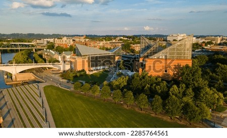 Captured from above, the Tennessee Aquarium in Chattanooga stands out with its modern design, surrounded by lush gardens and the flowing Tennessee River.