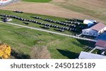 Captured from above, this image showcases an Amish community gathering, with a lineup of traditional horse-drawn buggies. Perfect for pieces on Amish culture, rural life, or transportation history