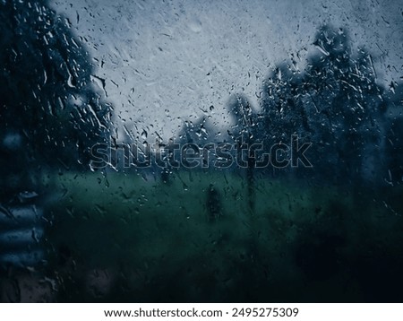 Captured from inside a house during heavy rain season, this image showcases dew drops on the window, creating a beautiful, misty view of the rainy season outside. heavy rain in Kuantan, Malaysia 

