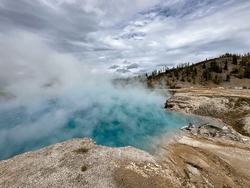 Captured In This Mesmerizing Photograph Is The Otherworldly Beauty Of A Yellowstone Hot Spring. Nature's Paintbrush Has Worked Wonders Here, Creating A Breathtaking Masterpiece Of Geothermal Wonder.