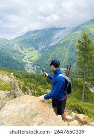 Capturing the Alpine View: A Hiker’s Pause Above the Valley. Vertical. sstkTravel
