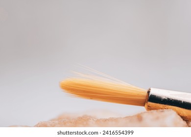 Capturing the Artistic Flair: Macro Close-Up of Synthetic Bristles on a Paintbrush with Gentle Touch and Subtle Background - Powered by Shutterstock