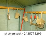 Capturing an authentic garden tool shed interior, with freshly used and uncleaned tools.