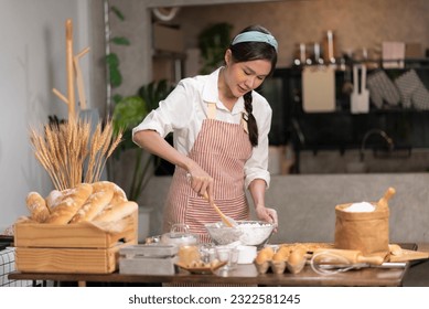 Capturing the essence of culinary artistry, an Asian woman crafts mouthwatering homemade bakery treats in her cozy kitchen, offering them for sale online to satisfy discerning palates. - Powered by Shutterstock