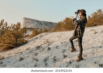 Capturing the majestic mountain woman photographing scenic landscape from hilltop on sunny day - Powered by Shutterstock