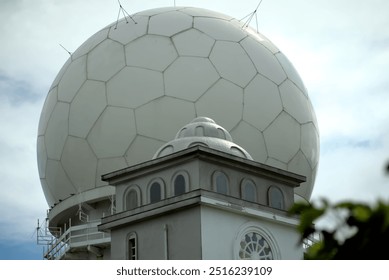 Capturing the Meteorological Radar Observatory on Sandiaojiao, uniquely shaped like a giant soccer ball, with a cloudy sky as the backdrop. - Powered by Shutterstock