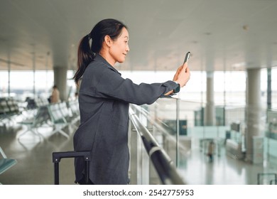 Capturing Moments: A Woman Taking Photos at the Airport   - Powered by Shutterstock