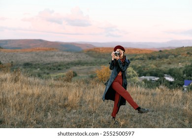 Capturing nature's beauty woman photographing scenic grassy field with camera on a sunny day - Powered by Shutterstock