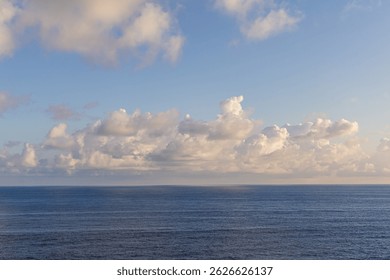 Capturing tranquility over the Pacific Ocean near Hawaii, under a sky filled with clouds.