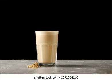 Capuccino In Glass Isolated On Black With Carob