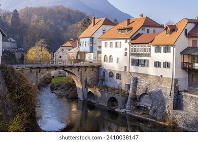 Capuchin Bridge in Skofja Loka over Selska Sora river, medieval town in Slovenia in autumn time