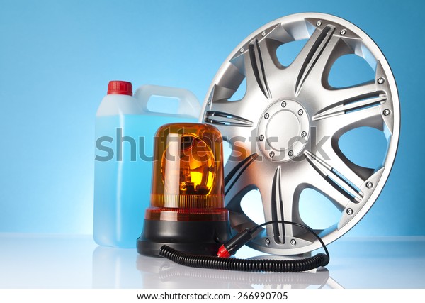 Car\
accessories - emergency vehicle amber beacon lighting with washer\
fluid and an alloy wheel on blue\
background