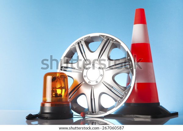 Car accessories - \
emergency vehicle amber beacon light with hubcap and traffic cone\
on blue background