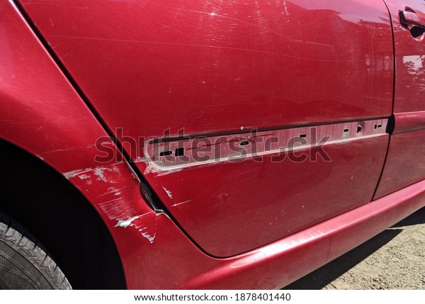 car accident dent on red\
car