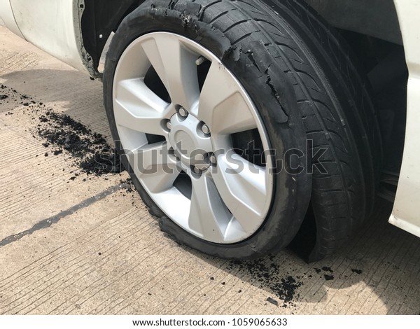 car\
accident. Car flat tire. wheel flat tire on the road. Closeup wheel\
explore. Dangerous car accident with flat tire. \
