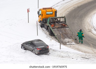 Car accident flipped upside down in accident during winter storm. The danger of driving in winter. Attention ice. Studded rubber. Skid car. Road safety flipped upside down accident during
