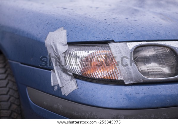 Car accident, insurance concept with adhesive tape\
on lights