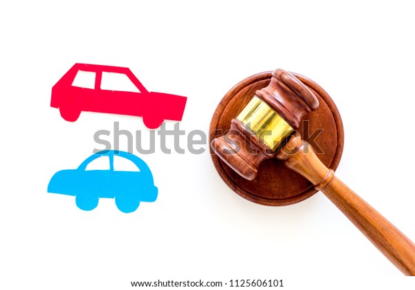 Car accident lawsuit concept.\
Two collided cars near judge gavel on white background top\
view