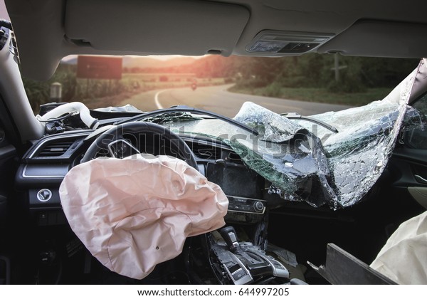 Car of accident make  airbag explosion damaged at\
claim the insurance company. Double exposure car accident and road\
with mountains. Image blur focus and Adjustment beautiful color\
sepia style.