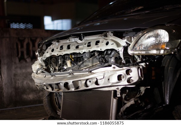 \
A car accident on a damaged car after a city\
collision, black background