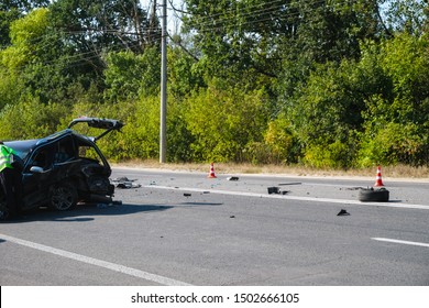 Car Accident On The Road. A Broken Car And Debris Blocked The Passage. Road Cones Warn Of Danger.