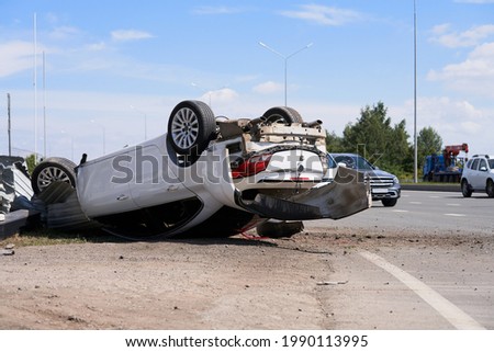 Car accident on the road. The motorist violated the speed limit, did not fit into the turn. The car rolled over, wheels up.                               