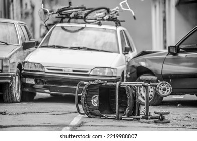 A Car Accident On The Street. An Overturned Baby Stroller Against The Background Of Colliding Cars