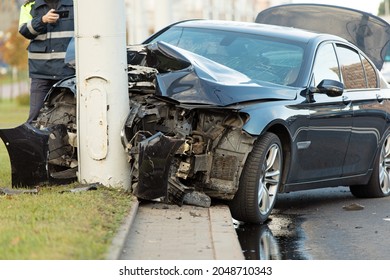 Car Accident. Police Officer Making Photo Vechicle. Driver Arrested After Crashing Into Utility Pole