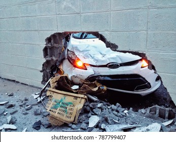 Car Accident, The White Car Crash Into The Brick Wall And Crushed Bumper.