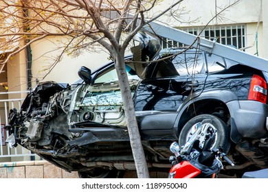 Car In An Accident,stuck Between Tree And A Fence,without Door And Wheel.Don't Drink And Drive