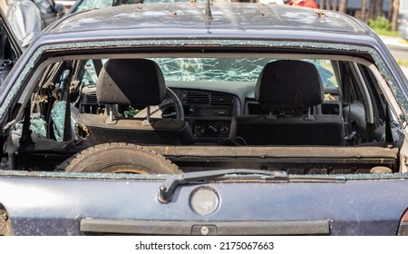 A Car After An Accident With A Broken Rear Window. Broken Window In A Vehicle. The Wreckage Of The Interior Of A Modern Car After An Accident, A Detailed Close-up View Of The Damaged Car