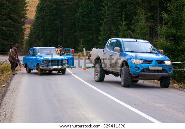 Car after accident into a\
ditch. vehicle towing. Car pulled out of the ditch in tow. accident\
on a steep road. Accident on a mountain road. September, 2016.\
Ukraine.