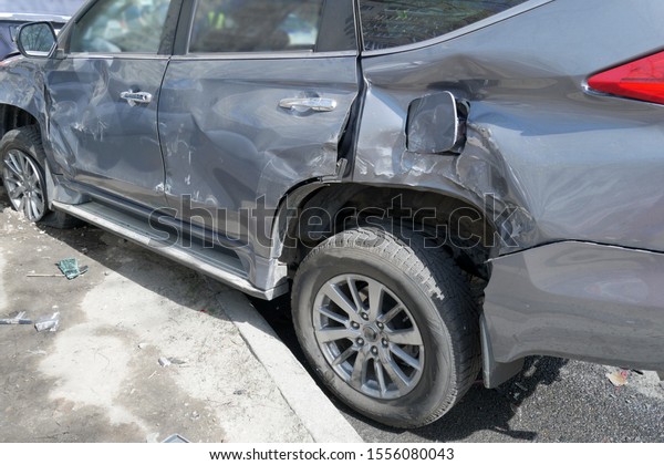 car after a big road\
accident, rumpled car trim and bumper, closeup, accident on the\
road in the city