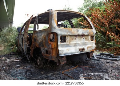 Car After A Fire. Burnt Rusty Car After Fire Or Accident. Car After The Fire, Crime Of Vandalism, Riots. Arson Car. Accident On The Road Due To Speeding. Explosion.