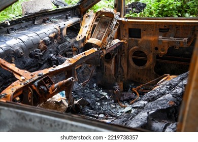 Car After A Fire. Burnt Rusty Car After Fire Or Accident. Car After The Fire, Crime Of Vandalism, Riots. Arson Car. Accident On The Road Due To Speeding. Explosion.