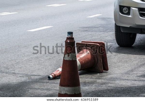 a car after hit traffic cone on the asphalt\
road, concept of breaking the\
rules