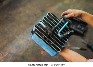 Car air conditioner evaporator coil close up.Auto mechanic worker fixing air condition system in car garage. Maintenance service, Repair checking vehicle engine tool.