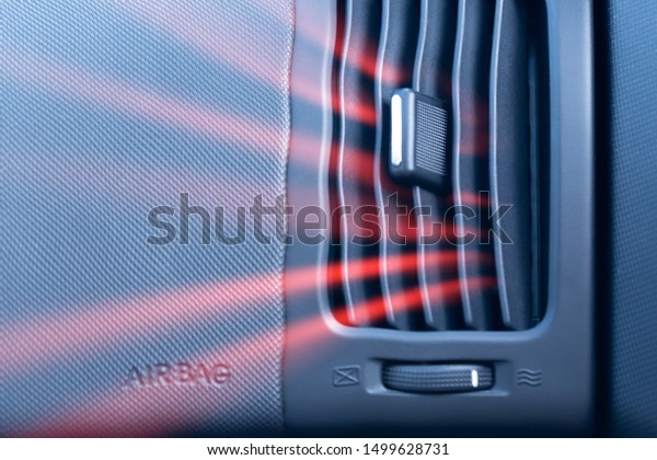 Car air conditioner\
with passenger airbag and illustration of hot air flow from it.\
Front view close up