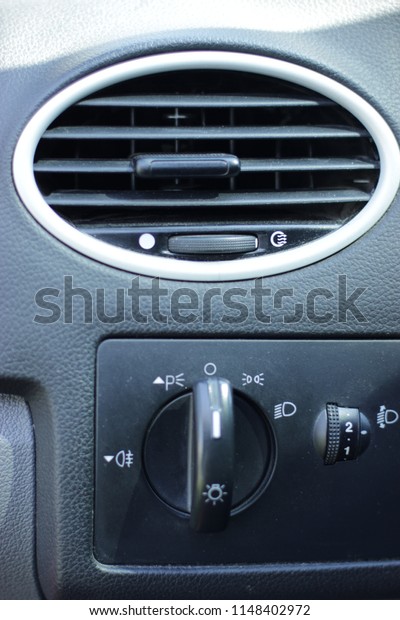 Car Air Conditioner and ventilation. HVAC in car.\
Oval lattice for air ventilation and conditioner in the automobile.\
Light control and adjustment of a corner of illumination of\
headlights from salon